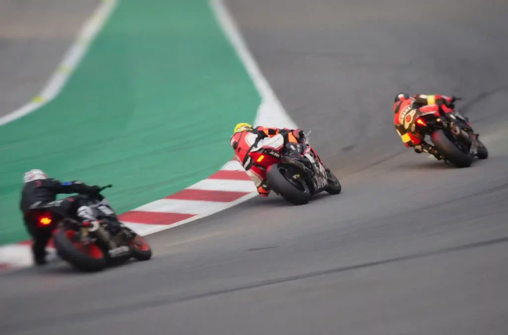 How are motorcycles races classified by engine size and track type?